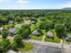 This aerial view showcases a lush, green neighborhood with well-maintained homes and mature trees with mountain view in the distance at 2519 2Nd Sw Ave, Hickory, NC 28602