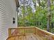 Charming backyard featuring a wood deck, siding, and lush trees, perfect for relaxing and enjoying nature at 2612 Cold Springs Rd, Concord, NC 28025