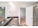 Well-lit bathroom featuring dual sink vanity and a step-in shower at 2612 Cold Springs Rd, Concord, NC 28025