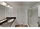 Bright bathroom with a glass shower, dark countertop and white vanity, creating a clean and modern look at 2612 Cold Springs Rd, Concord, NC 28025