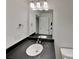 Bathroom vanity featuring dark countertop, mirror, and lighting fixtures creating a sleek and functional space at 2612 Cold Springs Rd, Concord, NC 28025