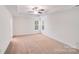 Expansive bedroom with a tray ceiling, ceiling fan, and two windows at 2612 Cold Springs Rd, Concord, NC 28025