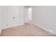 Neutral bedroom featuring a large closet and neutral carpeting at 2612 Cold Springs Rd, Concord, NC 28025