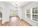Bright dining room with wood-look floors, chandelier and an abundance of natural light at 2612 Cold Springs Rd, Concord, NC 28025