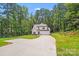 A charming two-story home with a large driveway, lawn, and a backdrop of trees at 2612 Cold Springs Rd, Concord, NC 28025