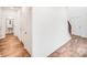 Hallway featuring wood-look floors, storage closets, and access to a powder room at 2612 Cold Springs Rd, Concord, NC 28025