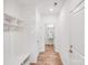 Hallway featuring wood-look floors, bench with hooks, and access to a powder room at 2612 Cold Springs Rd, Concord, NC 28025