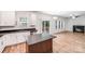 Open kitchen with stainless appliances, island, granite counters, and access to the deck and living room at 2612 Cold Springs Rd, Concord, NC 28025