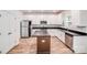 Bright kitchen features white cabinets, stainless appliances, and island with dark countertops at 2612 Cold Springs Rd, Concord, NC 28025