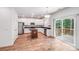 Well-lit kitchen featuring white cabinets, stainless steel appliances, and sliding glass doors to the outside patio at 2612 Cold Springs Rd, Concord, NC 28025