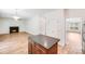 Modern kitchen with island, stainless appliances, and fireplace view in open floor plan at 2612 Cold Springs Rd, Concord, NC 28025