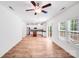 Open-concept living room with hardwood floors leading to the kitchen and outdoor patio at 2612 Cold Springs Rd, Concord, NC 28025