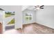 Bright living room featuring wood-look floors, large windows, and a modern ceiling fan at 2612 Cold Springs Rd, Concord, NC 28025