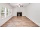Bright living room featuring a modern fireplace, a ceiling fan, and large windows at 2612 Cold Springs Rd, Concord, NC 28025