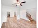 Spacious living room with wood-look floors, staircase and access to the kitchen and dining area at 2612 Cold Springs Rd, Concord, NC 28025