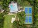Aerial view of community amenities including swimming pools and tennis courts amidst lush greenery at 2917 Rustic Ln, Charlotte, NC 28210