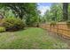 Large grassy backyard enclosed by a wooden fence for privacy and outdoor activities at 2917 Rustic Ln, Charlotte, NC 28210