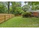 Spacious, enclosed backyard featuring a wooden fence and lush greenery at 2917 Rustic Ln, Charlotte, NC 28210