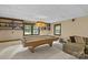 Basement featuring a pool table, a large couch, shelving, and carpeted floors at 2917 Rustic Ln, Charlotte, NC 28210