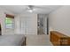 Bright bedroom featuring a ceiling fan, large windows, a closet, and a dresser at 2917 Rustic Ln, Charlotte, NC 28210