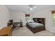 Bedroom featuring a bed, a desk and chair, a ceiling fan, and large windows at 2917 Rustic Ln, Charlotte, NC 28210