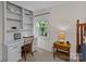 Bedroom features built-in shelving, desk area, a window, and a lamp on a wooden bedside table at 2917 Rustic Ln, Charlotte, NC 28210