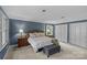 Comfortable bedroom features soft lighting, neutral carpet, and abundant closet space at 2917 Rustic Ln, Charlotte, NC 28210