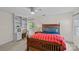 Bedroom features built-in shelving, desk area, a window, and a bed with bright bedding at 2917 Rustic Ln, Charlotte, NC 28210