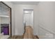 Bright hallway with wood-look flooring and neutral paint, leading to doorways at 2917 Rustic Ln, Charlotte, NC 28210