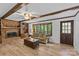 Inviting living room with fireplace, built-ins, hardwood floors, and ample natural light at 2917 Rustic Ln, Charlotte, NC 28210