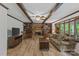 Cozy living room featuring a brick fireplace, built-in bookshelves, and wood beam ceilings at 2917 Rustic Ln, Charlotte, NC 28210