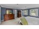 Main bedroom with a dresser, a mirror, and large windows providing natural light at 2917 Rustic Ln, Charlotte, NC 28210