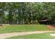 Community playground featuring slides and covered picnic area set in a natural, green setting at 2917 Rustic Ln, Charlotte, NC 28210