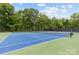 Outdoor tennis court with a green and blue surface, perfect for recreational play at 2917 Rustic Ln, Charlotte, NC 28210