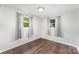 Bedroom with hardwood floors, neutral walls, and two large windows letting in plenty of natural light at 307 Elm St, Belmont, NC 28012