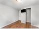 Bedroom with hardwood floors, neutral walls, and a mounted flat-screen television at 307 Elm St, Belmont, NC 28012