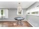 Bright dining area with modern chandelier, hardwood floors, and ample natural light at 307 Elm St, Belmont, NC 28012