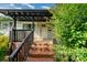 Inviting front entrance with brick steps, dark railing, and a covered porch area at 307 Elm St, Belmont, NC 28012