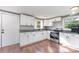 Bright kitchen featuring white cabinets, granite counters, stainless steel appliances, and hardwood flooring at 307 Elm St, Belmont, NC 28012