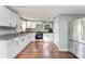 Modern kitchen featuring stainless steel appliances, granite counters, and white cabinetry at 307 Elm St, Belmont, NC 28012