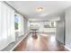 Bright living room with hardwood floors and neutral paint, complemented by white curtains at 307 Elm St, Belmont, NC 28012