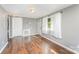 Inviting living space with hardwood floors, neutral paint, and bright windows with sheer curtains at 307 Elm St, Belmont, NC 28012