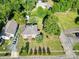 Aerial view of a well-maintained home with a landscaped yard, mature trees, and surrounding neighborhood at 309 S Greene St, Wadesboro, NC 28170