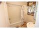 Bathroom featuring a bathtub with shower and decorative floral curtains at 309 S Greene St, Wadesboro, NC 28170