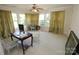 Spacious bedroom with large windows, a ceiling fan, neutral walls, and carpeted floors at 309 S Greene St, Wadesboro, NC 28170