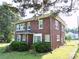 A brick two-story home with green bushes in the front yard at 309 S Greene St, Wadesboro, NC 28170