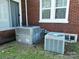 Exterior view of the home's HVAC units installed on the lawn, next to the brick home at 309 S Greene St, Wadesboro, NC 28170