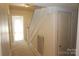 Bright hallway features carpet flooring, staircase with white railings, and a convenient storage closet at 309 S Greene St, Wadesboro, NC 28170