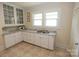 Charming kitchen featuring granite countertops, white cabinets and stainless steel double sink at 309 S Greene St, Wadesboro, NC 28170