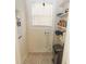 Narrow laundry room with storage shelves and connections for a washing machine at 309 S Greene St, Wadesboro, NC 28170